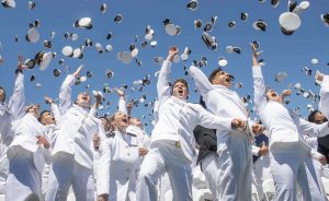 A group of midshipmen celebrating at graduation
