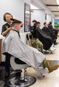 Midshipmen having their hair cut in the barber shop