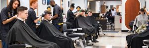 Midshipmen getting haircuts in the barber shop