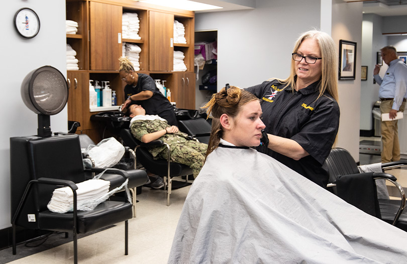 Midshipmen having their hair styled and shampooed in the beauty shop