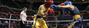 A Naval Academy student boxing in the ring