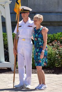 A mother posting for a photograph with her midshipman son