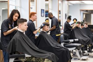 Midshipmen getting haircuts in the barber & beauty shop
