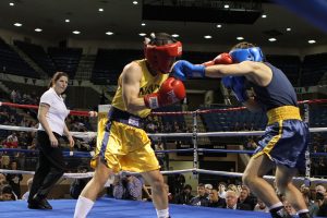 A midshipman boxing with an opponent