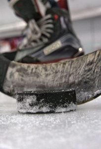 Closeup of a hockey stick and puck
