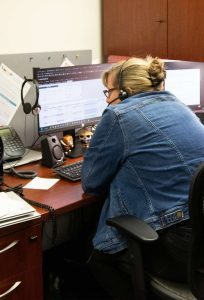 A technician in the MCRC sitting at a desk