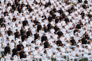A large group of midshipmen seated