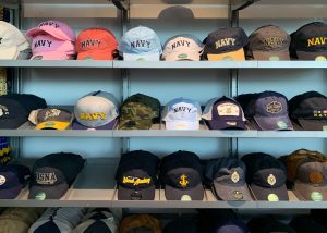 Hats on a shelf in the USNA gift shop
