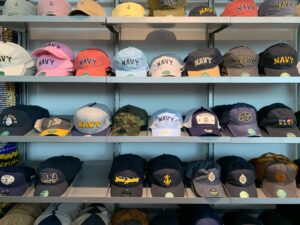 A variety of hats displayed on a shelf in the gift shop
